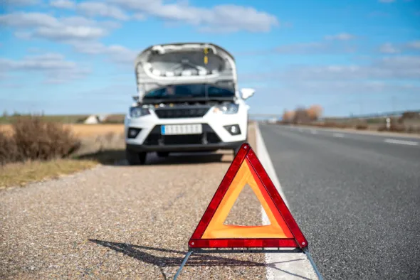 Auto uszkodzone w kolizji drogowej. Stoi na poboczu, czekając na pomoc