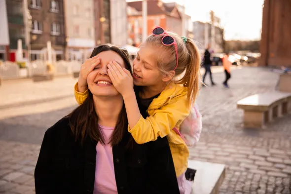 Mother and child exploring a charming street during a family trip in Poland