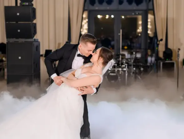 Romantic first dance of bride and groom at wedding reception