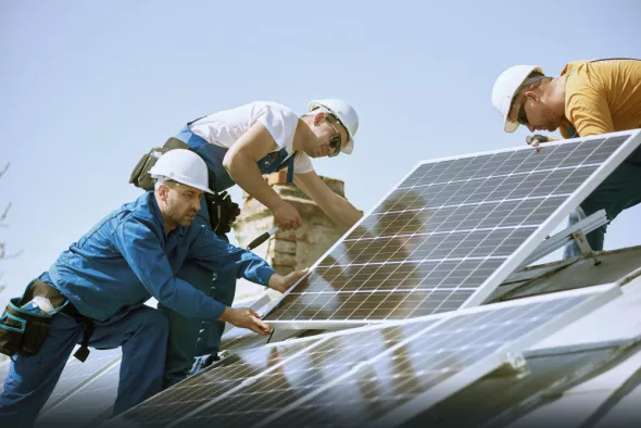 RES workers install solar panels