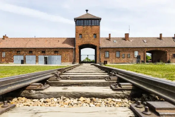 Main entrance to the Auschwitz I Memorial and Museum in Oświęcim, an important historical day trip from Kraków