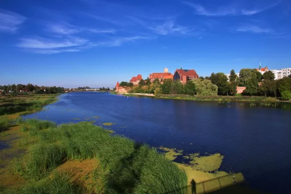 distant view of Malbork castle, and the Nogat river