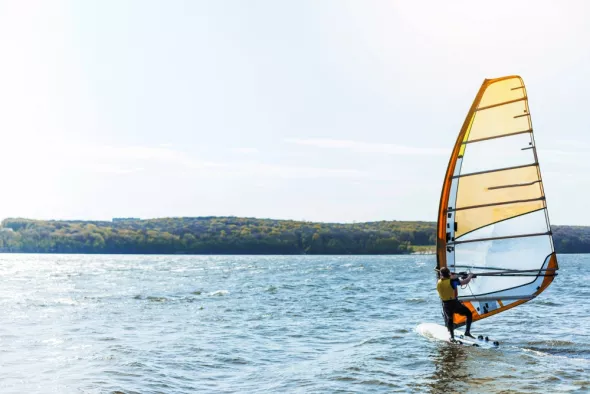 A young man on a kitesurfing board on Lake Sniardwy