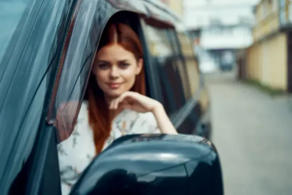 Woman sitting in a rental car