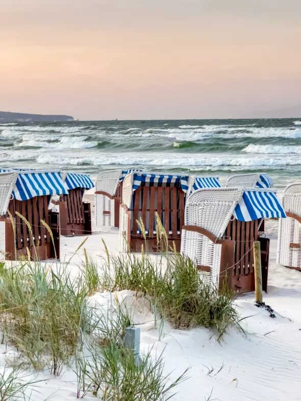  Sandy beach by sea with dressing rooms.