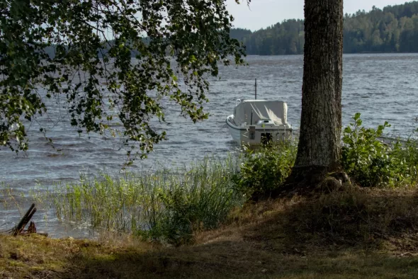 A scenic view of a boat on a Masurian lake
