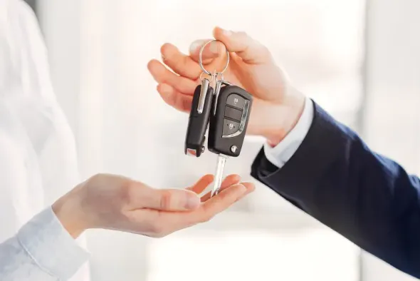 The representative hands over the keys to the rental car in Kielce