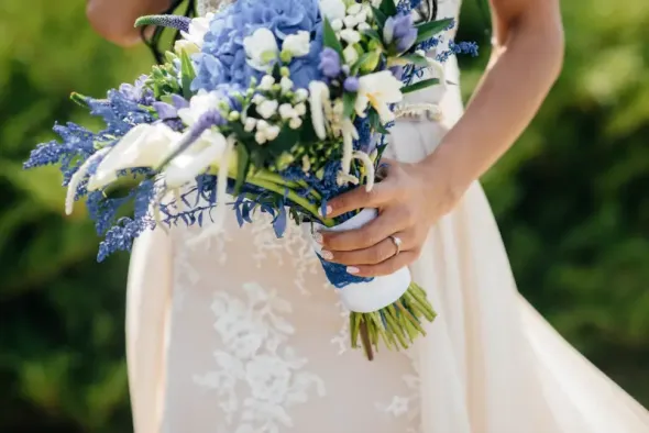 White wedding bouquet with blue accents for bride