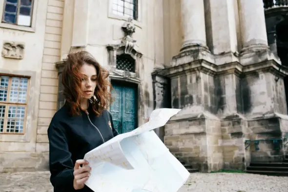 Woman holding a tourist map while visiting Warsaw, Poland