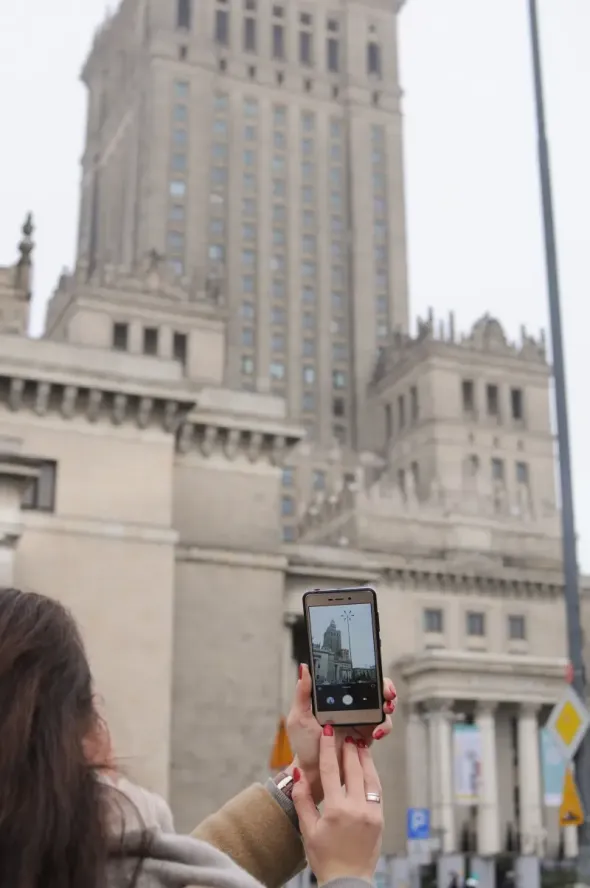 Traveller taking photos during a one-day trip from Warsaw by car