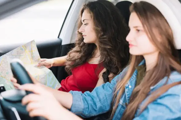 Passenger checking map during road trip