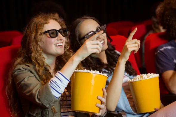 People looking at cinema screen during film screening