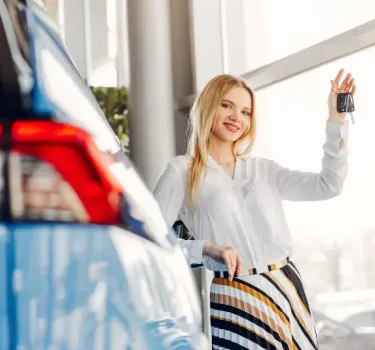 Elegant woman completing car rental process at counter