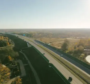 Top view of Polish freeway with cars driving through green landscape and grassy surroundings