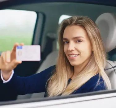 Young traveler holding IDP document for driving in Poland
