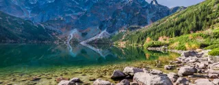 Colorful autumn sunrise over a lake in the Tatra Mountains