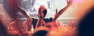 Festival audience dancing and cheering during live performance