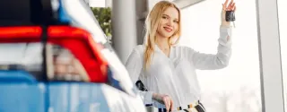 Elegant woman completing car rental process at counter