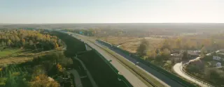 Top view of Polish freeway with cars driving through green landscape and grassy surroundings