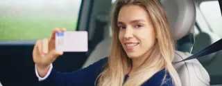 Young traveler holding IDP document for driving in Poland