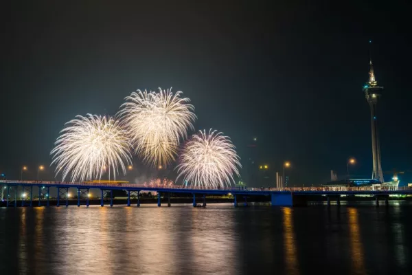 Sztuczne ognie nad miastem odbijają się w lustrze wody