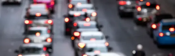 A busy road in Poland during rush hour, with cars stuck in a traffic jam, illustrating traffic conditions and driving conditions for tourists.