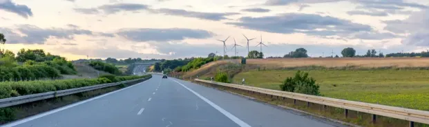 Wind turbines on hills in a renewable energy landscape showing sustainable infrastructure and countryside horizon